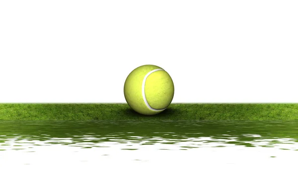 Теннисный мяч на зеленой траве — стоковое фото