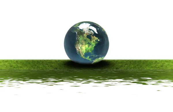 Erde auf dem grünen Gras — Stockfoto
