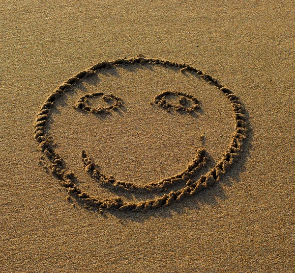 stock image Smile drawn on the sand