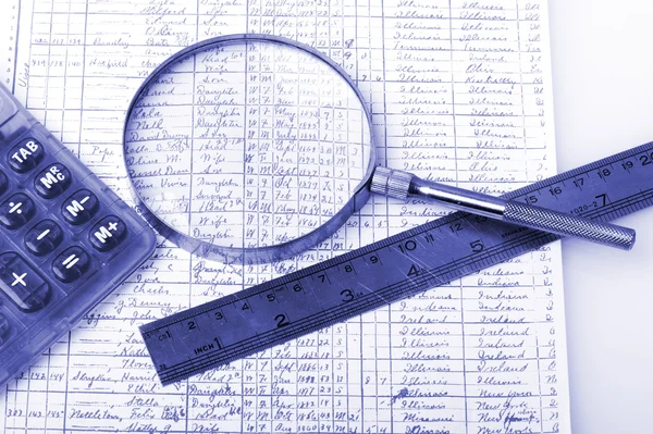 Closeup of a chart with a magnifying glass on white — Stock Photo, Image