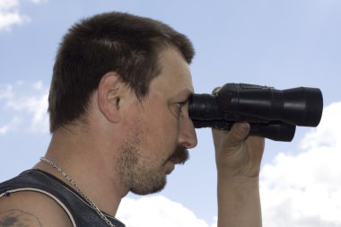 Man look through the binoculars clipart