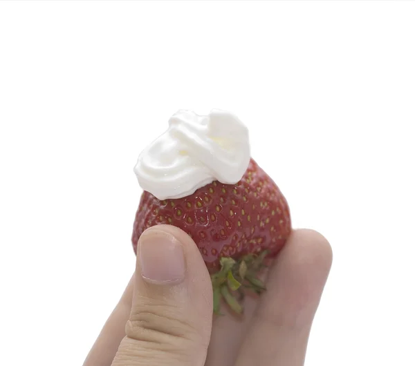 Red strawberry with cream in fingers — Stock Photo, Image