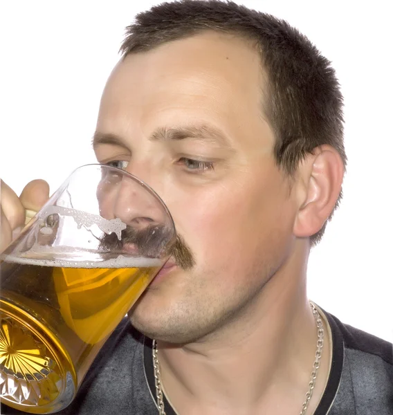 Close up of young man drinking beer from glass mug — Stock Photo © Syda
