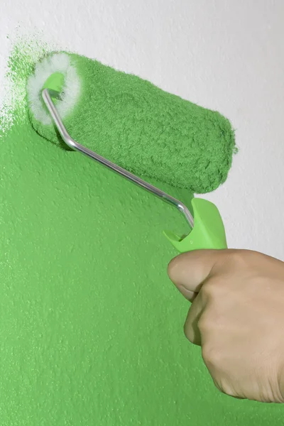 Green roller coloring on white surface — Stock Photo, Image