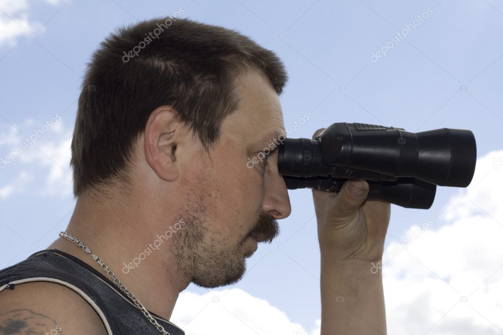 Man look through the binoculars