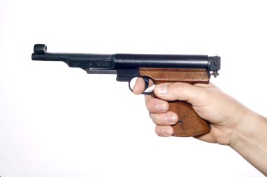 Pneumatic pistol in hand over white clipart