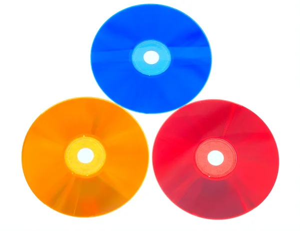 Počítačové disky různých barev na — Stock fotografie