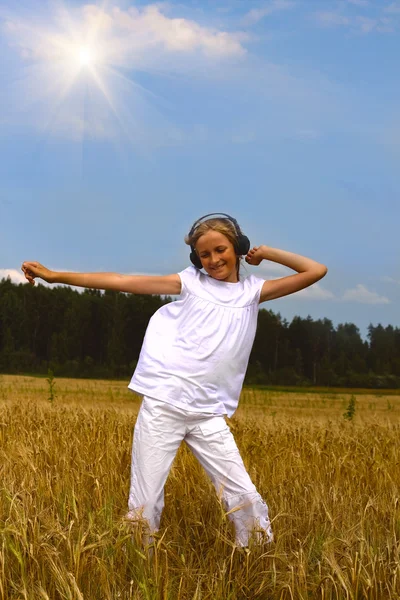 Krásné dospívající dívka tančí na pšenici — Stock fotografie