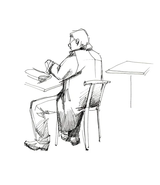 Man in een overjas aan de tafel van de — Stockfoto