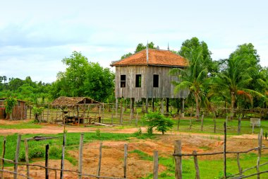 Low buildings in Cambodian jungles clipart