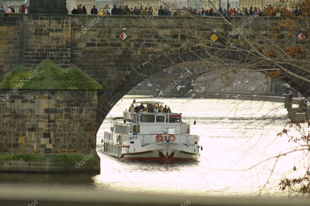 Tourist boat under The Charles Bridge