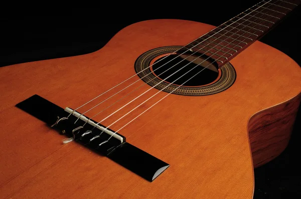 Six string guitar against a dark backgro Stock Photo