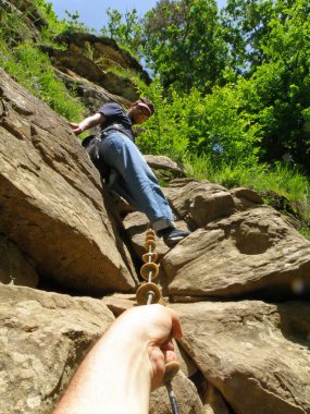 The rock-climber against green trees clipart