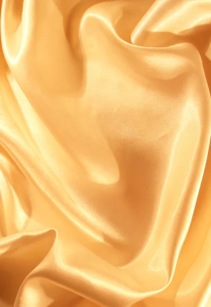 Гладкий елегантний золотий шовк як фон — стокове фото