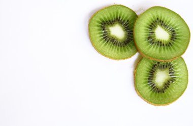 Green kiwi slices isolated on white as b clipart