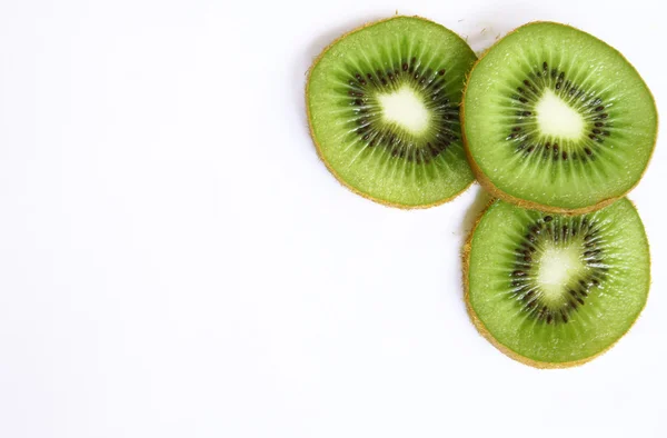 Stock image Green kiwi slices isolated on white as b