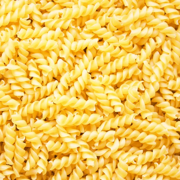 Pasta fusili as background — Stock Photo, Image