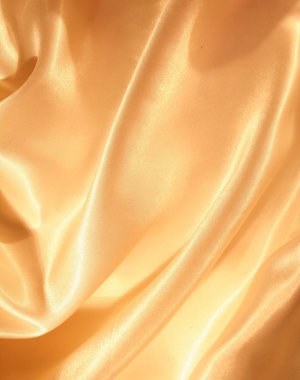 Smooth elegant golden silk as background clipart