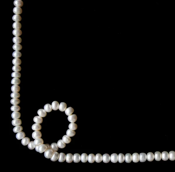 White pearls on the black background — Stock Photo, Image