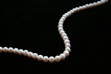 Pearls necklace on the black background clipart