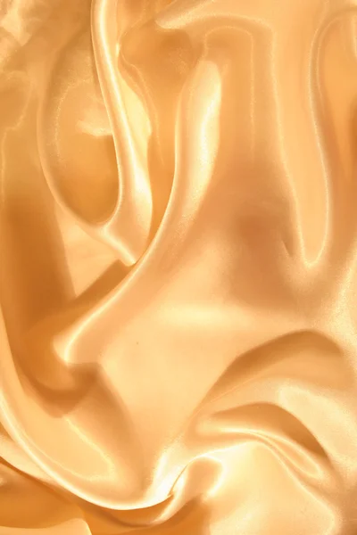 Гладкий элегантный золотой шелковый фон — стоковое фото