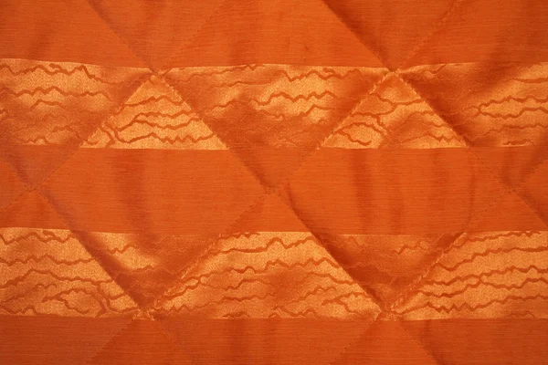 Hladké zlaté a oranžové textilie — Stock fotografie