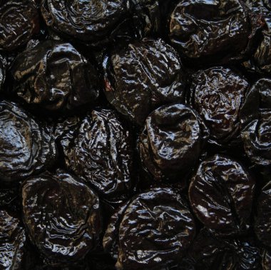 Dry plums or prunes fruit as background clipart