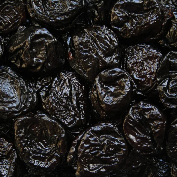 Dry plums or prunes fruit as background — Stock Photo, Image