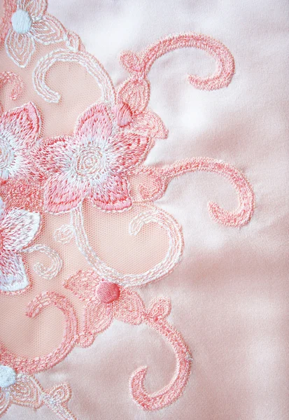 Flower lace on the elegant pink silk — Stock Photo, Image