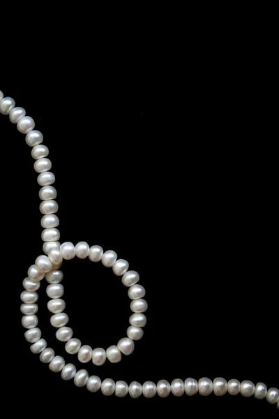 White pearls on the black silk — Stock Photo, Image