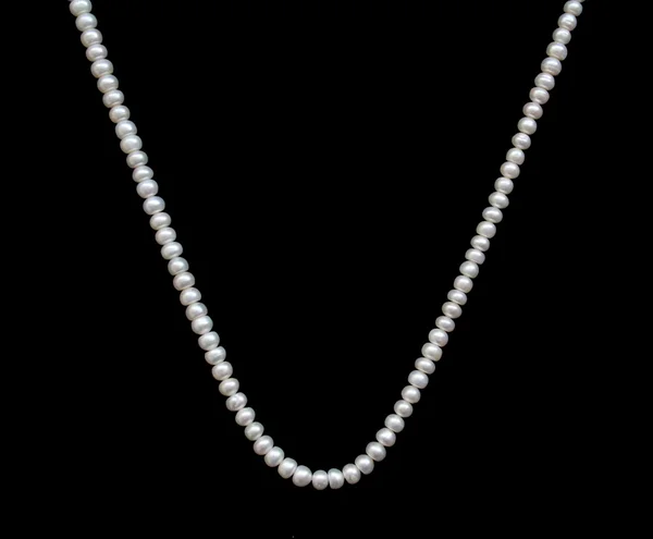 stock image White pearls on the black silk