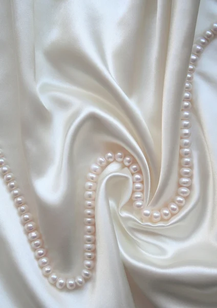 Smooth elegant white silk with pearls — Stock Photo, Image
