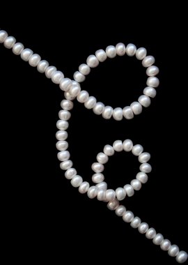 White pearls on the black silk clipart