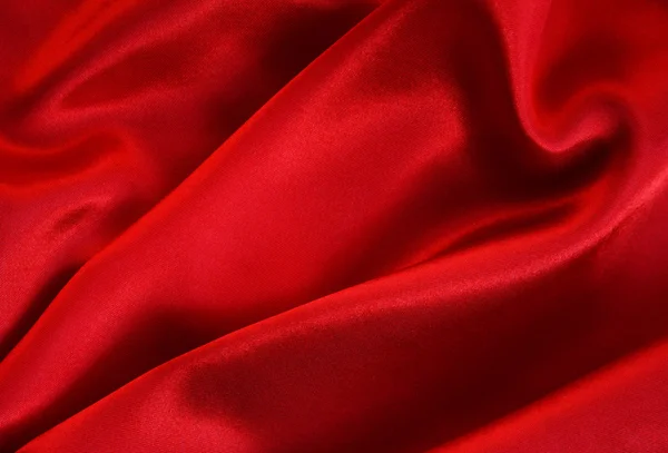 Гладкий красный шелк в качестве фона — стоковое фото