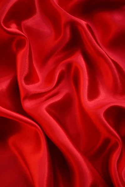 Гладкий элегантный красный шелк в качестве фона — стоковое фото