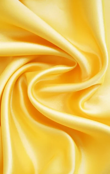 Гладкий элегантный золотой шелк — стоковое фото