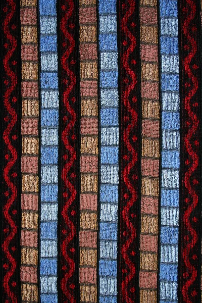 Röd, brun och blå stickad texturerat — Stockfoto
