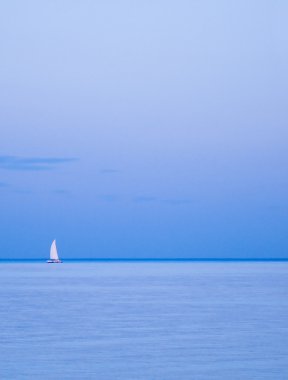 Lonely yacht on horizon clipart