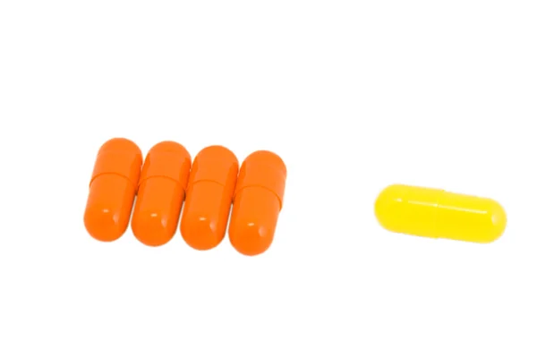 Píldoras vitamínicas en blanco aislado — Foto de Stock