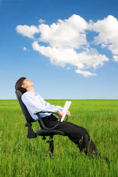 Businessman relaxing on grassland — Stock Photo, Image