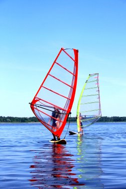 Windsurfing is on Latvian lake clipart