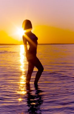 Silhouette of a woman in the sea clipart