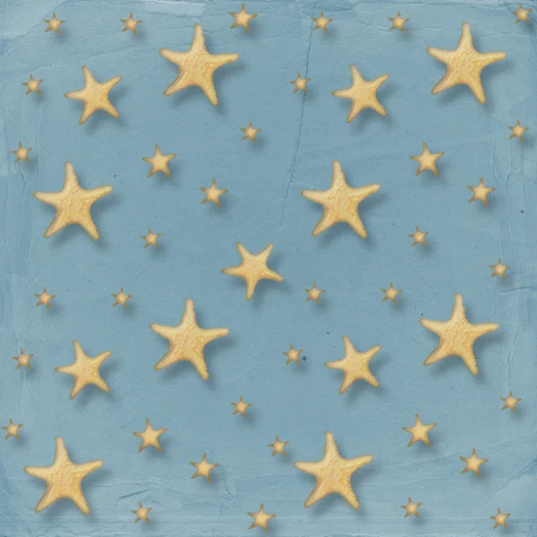 Mořské hvězdy na abstraktní papíru poz — Stock fotografie