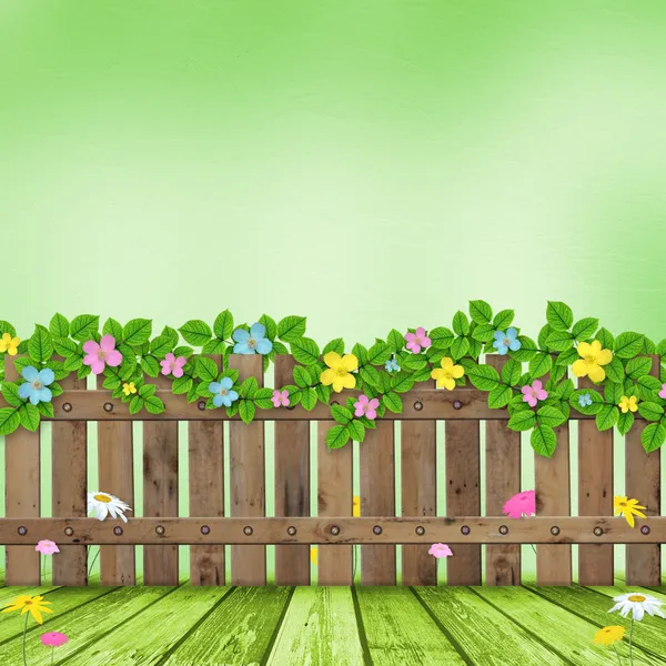 Houten hek met een bloem krans — Stockfoto
