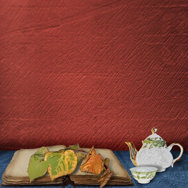 The old book with leaves and teapot with cup o — Stock Photo, Image