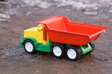 Baby toy dump truck in dirt