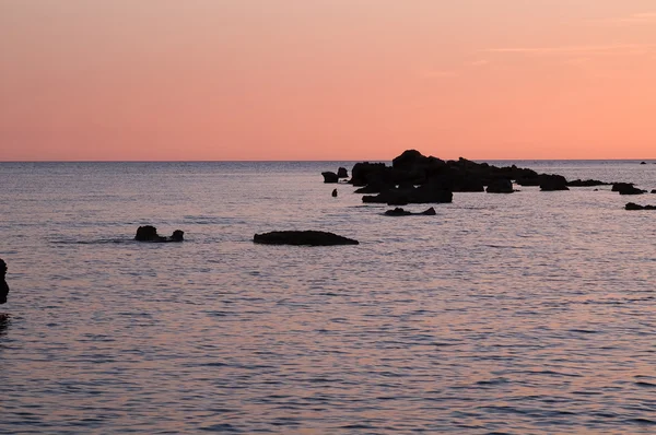 stock image Red sunset with sea and rocks