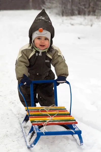 Baby pushing sled — Stock Photo, Image