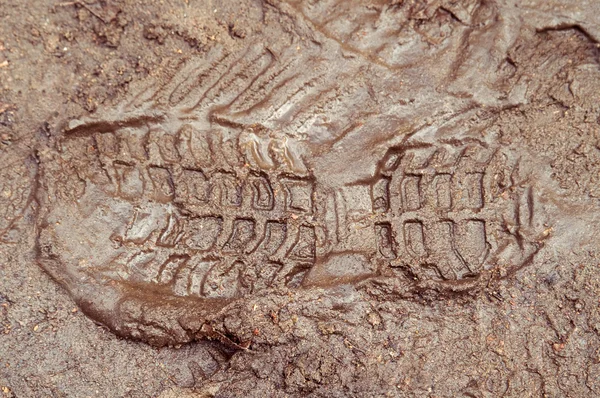 Boot print in brown mud — Stock Photo, Image