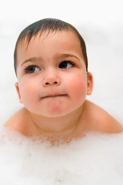 Thoughtful year old boy in foam — Stock Photo, Image